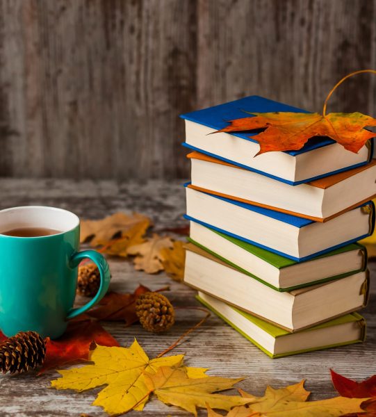 Autumn.A Cup of tea. Books colorful. Yellow red Leaves